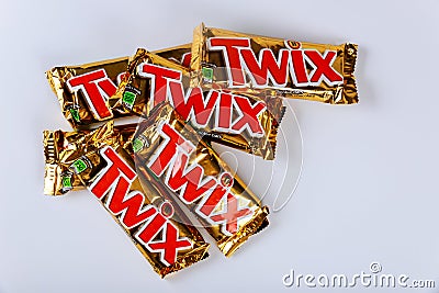 Twix is a chocolate bar consisting of biscuit applied with caramel and milk chocolate made by Mars, Inc. on white background Editorial Stock Photo
