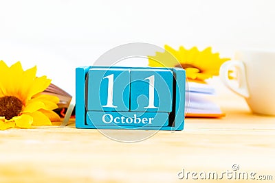 October 11 on the wooden calendar.The eleventh day of the autumn month, a calendar for the workplace. Stock Photo