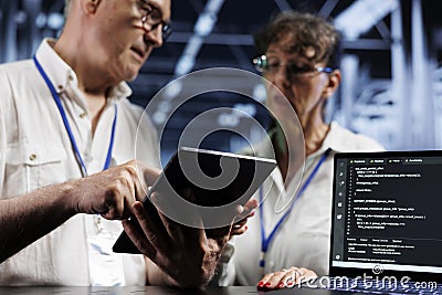 Octogenarian executives update servers Stock Photo