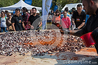 Octopus small chopped bites, street food festival. Seafood festival. Live cooking session contest Editorial Stock Photo