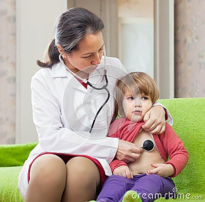 Octor examining 2 years baby with stethoscope Stock Photo
