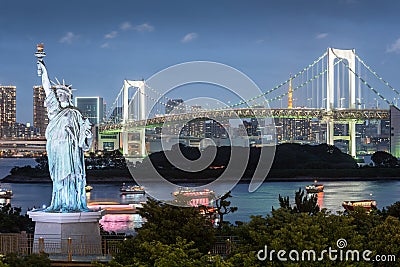 Odaiba Statue of Liberty with rainbow bridge and Tokyo tower in evening Stock Photo