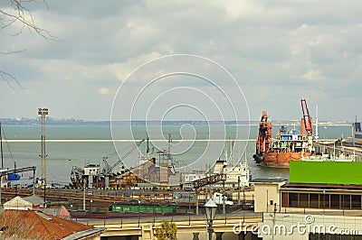 ODESA, UKRAINE - March 04. 2015. Seaport with cargo loading cranes, railway and pier. Autumn at sea Editorial Stock Photo