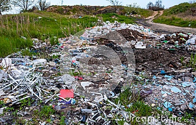 Heaps of plastic trash on the shore of the reservoir. Ecology of nature Editorial Stock Photo