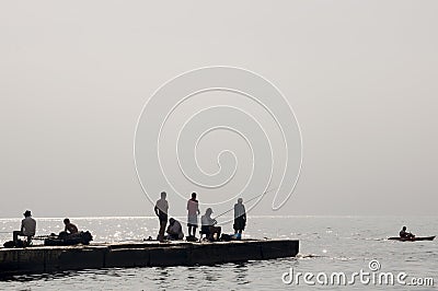 Odessa, South of Ukraine, Coast of a Black Sea, beach Langeron, June 28, 2018. Silhouettes of people resting at the water. Calm. M Editorial Stock Photo
