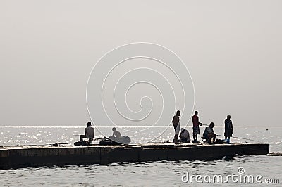 Odessa, South of Ukraine, Coast of a Black Sea, beach Langeron, June 28, 2018. Silhouettes of people resting at the water. Calm. M Editorial Stock Photo