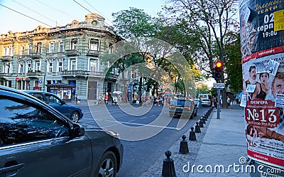 Odessa, Ukraine â€“ August 4, 2020: Preobrazhenskaya street near the Cathedral square and city Park, green trees and people, road Editorial Stock Photo