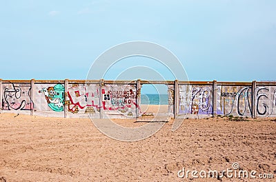 Odessa, Ukraine - 04 20 21: a hole in fence with graffiti as an entrance to Fishing Port beach in Sauvignon district Editorial Stock Photo