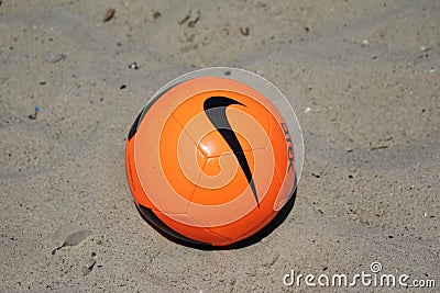 ODESSA UKRAINE - JULY 28, 2019: Beach soccer ball in the sand. Beach soccer ball on the sea sand while children play at a local Editorial Stock Photo
