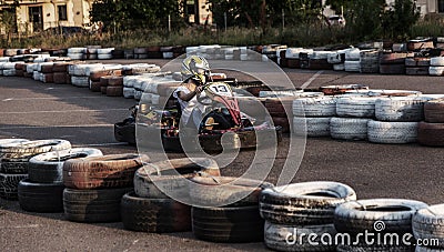 ODESSA, UKRAINE - June 19, 2019: karting. Racers on races on special safe high-speed tracks limited by car tires. Attraction High- Editorial Stock Photo