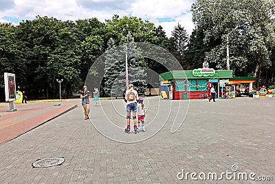Odessa, Ukraine. March,2020.. Family Day. Parents` active leisure on foot with children in wheelchairs, roller skates, bicycles o Editorial Stock Photo