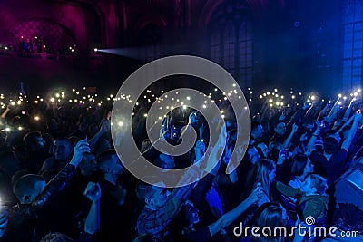 ODESSA, UKRAINE - March 23, 2019: viewers in auditorium of concert hall emotionally meet their favorite performers. Audience in Editorial Stock Photo