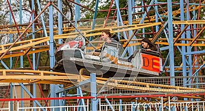 ODESSA, UKRAINE - MAY 6, 2019: Visitors ride road slides in an amusement park. Young friends on an exciting rollercoaster. Young Editorial Stock Photo