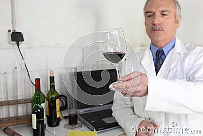 Oenologist examining glass of wine Stock Photo