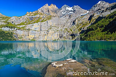 Oeschinensee alpine lake with high spectacular mountains and glaciers, Switzerland Stock Photo