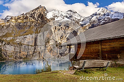 Oeschinnensee, wooden chalet and Swiss Alps, Switzerland. Stock Photo