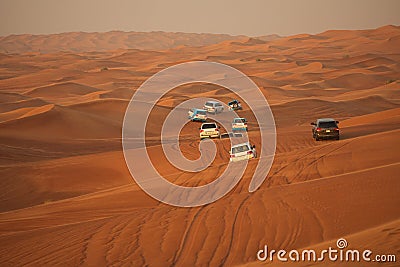 Off-road adventure with SUV driving in Arabian Desert at sunset. Offroad vehicle bashing through sand dunes in Dubai desert. Tradi Editorial Stock Photo