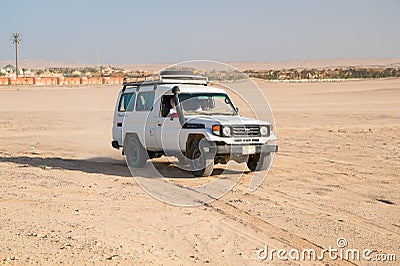 Off road car drive on desert landscape. Jeep for safari on sunny blue sky. Truck automobile travel in sand dune. Wanderlust and ad Editorial Stock Photo