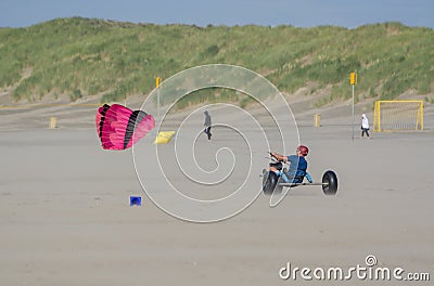 Off-road driving wind buggy on sandy beach with green sandy dunes Editorial Stock Photo