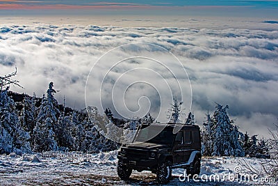 Off-road travel on snow mountain road. Winter ravel concept with 4x4 car. Jeep offroad outdoors adventures. Stock Photo