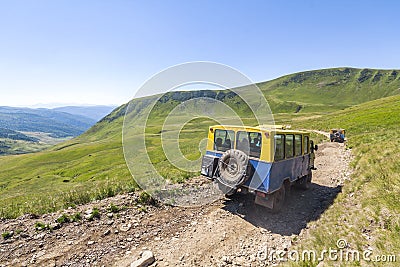 Off-road vehicle goes on the mountain gravel road way. Editorial Stock Photo