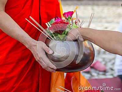 Offer sacrifice flowers to monk Stock Photo