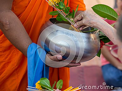 Offer sacrifice flowers to monk Stock Photo