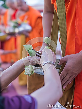 Offer sacrifice flowers to monk Stock Photo