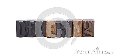 OFFERING spelled in wooden block letters Stock Photo