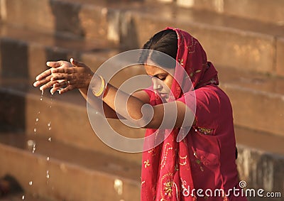 Varanasi - India - Woman Making an Offering to the Gods Editorial Stock Photo