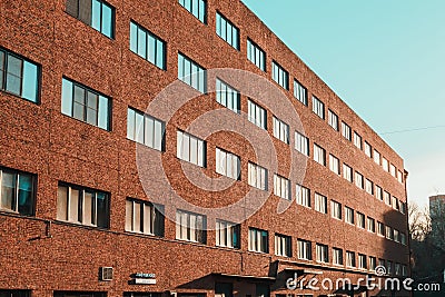 Office building in loft style with walls made of red brick. Facade of commercial office with windows Editorial Stock Photo