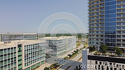 Office buildings and modern condominium tower surrounding by multistory apartment building, modern villas, in downtown Plano, Editorial Stock Photo