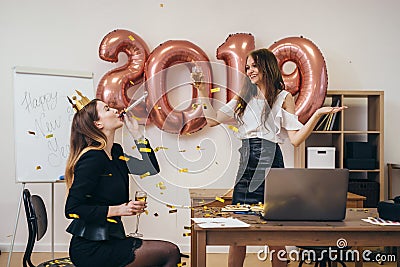 Office christmas party. Group of female colleagues having fun at new year celebration Stock Photo