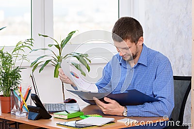 Office clerk reads documents in a folder Stock Photo