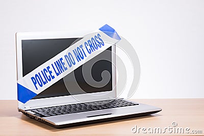 Office computer laptop and police crime scene tape Stock Photo