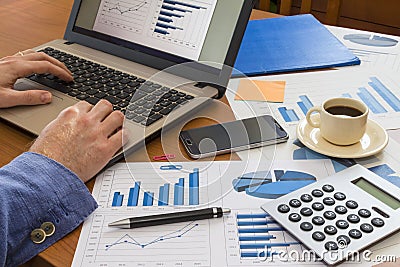 Office desk with charts , histograms and financial documents Stock Photo