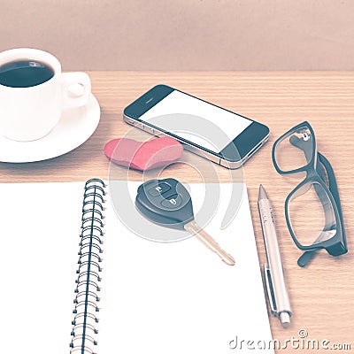 office desk : coffee and phone with car key,eyeglasses,notepad,heart vintage style Stock Photo