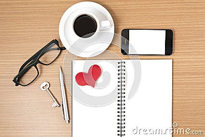 office desk : coffee and phone with key,eyeglasses,notepad,heart Stock Photo