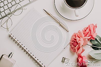 Office desk with computer and rose flowers Stock Photo