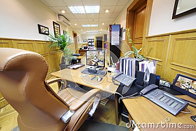 Office with desk, computer, telephones and folders Stock Photo