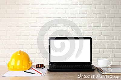Office desk of construction engineers Helmet and accessories White computer screen. Stock Photo