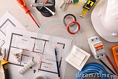 Office desk of electrical engineer with installation project and tools Stock Photo