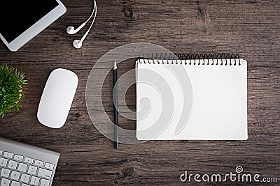 The office desk flat lay view with keyboard, mouse, tree, book, pencil and earphone on wood texture background Stock Photo
