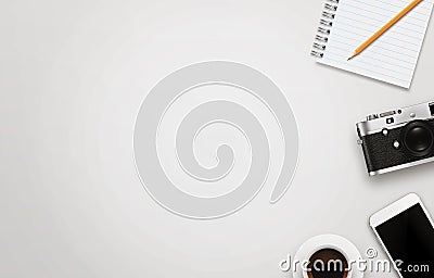 Office desk with free space for text. Camera, cup of coffee, smart phone, notepad, pencil on white table. Stock Photo