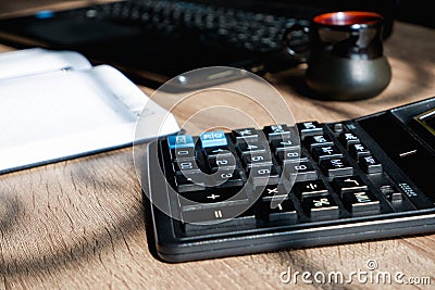 Office desk of startup businessman near the window with a laptop, books and a calculator. Business or work concept Stock Photo