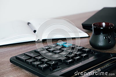 Office desk of startup businessman near the window with a laptop, books and a calculator. Business or work concept Stock Photo