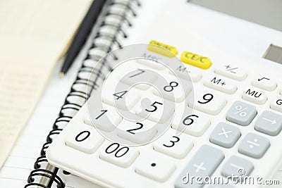 Office desk table calculator with notepad book, bank account and black pen. Stock Photo