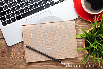 Office desk table with computer, supplies, coffee cup and flower Stock Photo