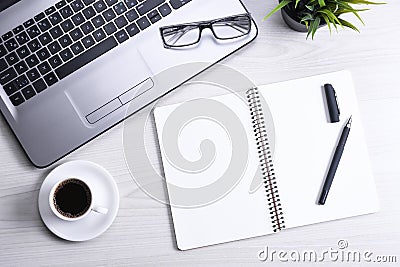 Office desk table with laptop, smart phone, cup of coffee and supplies, on wooden background. Top view with copy space, flat lay Stock Photo