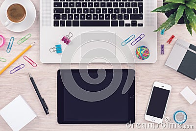 Office desk table workplace with macbook laptop keyboard, ipad tablet pc and iphone smartphone top view Stock Photo